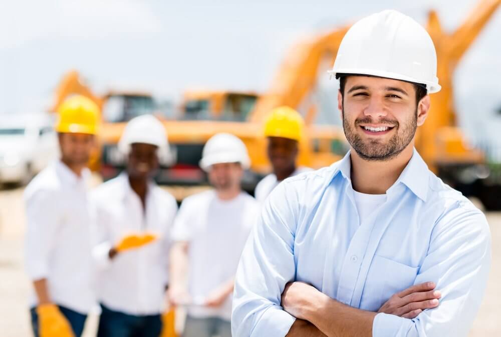 Successful male architect at a building site with arms crossed Successful male architect at a building site with arms crossed